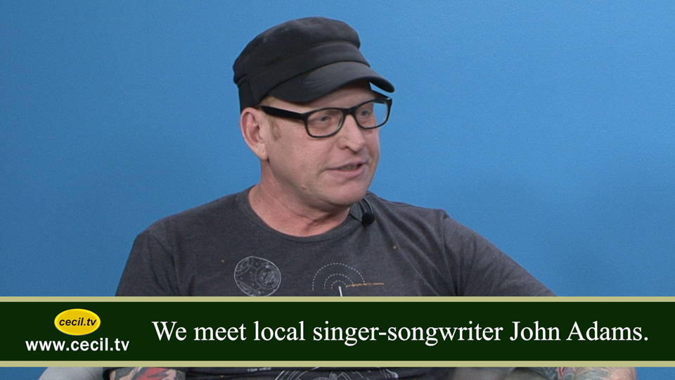 We meet local singer-songwriter John Adams.